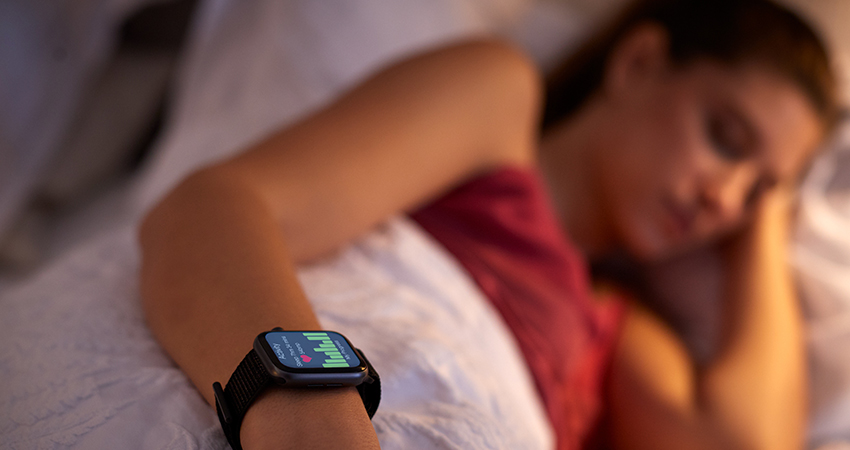 Woman using smart watch for sleep tracking