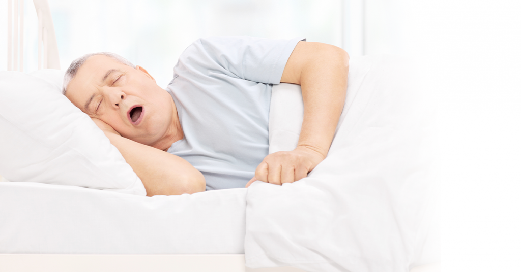 Man sleeping and snoring in bed